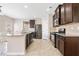 A well-equipped kitchen features dark wood cabinetry, stainless steel appliances, and granite countertops at 4920 Fourth Rail Ln, Cumming, GA 30040