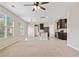 Large living room with kitchen, fireplace, and big windows for lots of natural light at 4920 Fourth Rail Ln, Cumming, GA 30040