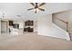 Open floor plan featuring living room with stairwell, kitchen, and breakfast bar at 4920 Fourth Rail Ln, Cumming, GA 30040
