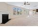 A sun-filled living room with a fireplace and views into the kitchen area at 4920 Fourth Rail Ln, Cumming, GA 30040
