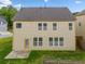 Beige two-story home featuring a well-manicured lawn and backyard at 4920 Fourth Rail Ln, Cumming, GA 30040