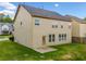 Well maintained beige home with a manicured lawn at 4920 Fourth Rail Ln, Cumming, GA 30040