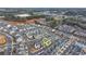 Aerial view of the neighborhood with rows of houses nestled among wooded areas and winding streets at 1006 Fendley St, Woodstock, GA 30188