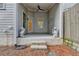 Image of back porch with statue decor and steps leading down to yard area at 1006 Fendley St, Woodstock, GA 30188