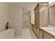 Bathroom with marble floors, walk in shower, and a modern tub at 1006 Fendley St, Woodstock, GA 30188