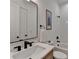 Modern bathroom with a sleek vanity, white subway tiles, and black fixtures create a spa-like experience at 1006 Fendley St, Woodstock, GA 30188
