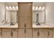 Luxurious bathroom featuring double sinks, cabinets, and lighting fixtures at 1006 Fendley St, Woodstock, GA 30188