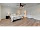Spacious bedroom featuring hardwood floors, white walls, and a ceiling fan at 1006 Fendley St, Woodstock, GA 30188