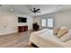 This bedroom has two windows, hardwood floors, and a TV at 1006 Fendley St, Woodstock, GA 30188