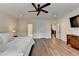 Light-filled bedroom with hardwood floors, ceiling fan, and ensuite bathroom at 1006 Fendley St, Woodstock, GA 30188
