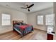 Bright bedroom features beautiful hardwood floors, large windows, and a stylish ceiling fan at 1006 Fendley St, Woodstock, GA 30188