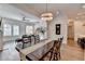 Open dining area features a wooden table, chandelier, hardwood floors, and an open view into the living room at 1006 Fendley St, Woodstock, GA 30188