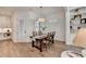 Elegant dining area features a wooden table, a chandelier, plantation shutters, and built-in shelving at 1006 Fendley St, Woodstock, GA 30188