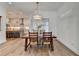 The dining area boasts a wooden table, chandelier, and an open concept design, connecting to a modern kitchen at 1006 Fendley St, Woodstock, GA 30188