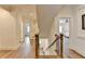 Bright hallway with wooden floors, stairs with dark iron railings, and white trim, offering a clean and modern aesthetic at 1006 Fendley St, Woodstock, GA 30188