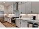 Updated kitchen has ample counter space, stainless appliances, and sleek, modern finishes at 1006 Fendley St, Woodstock, GA 30188