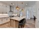Bright kitchen features a spacious island with seating, stainless steel appliances, and pendant lighting at 1006 Fendley St, Woodstock, GA 30188