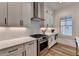 This functional kitchen features white cabinets, stainless steel appliances, and stylish backsplash at 1006 Fendley St, Woodstock, GA 30188