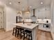 Modern kitchen features stainless steel appliances, an island with bar seating, and elegant pendant lighting at 1006 Fendley St, Woodstock, GA 30188