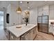 Well-designed kitchen features a large center island, stainless appliances and ample counter space at 1006 Fendley St, Woodstock, GA 30188