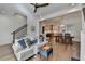 Spacious living room with hardwood floors, a staircase, a comfortable sofa, and an open view to the dining area at 1006 Fendley St, Woodstock, GA 30188