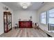 Bright living room with hardwood floors, complemented by a display cabinet, a dark wood credenza and natural light at 1006 Fendley St, Woodstock, GA 30188
