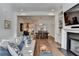 Open living space with fireplace, built-ins, hardwood floors, and view into kitchen and dining areas at 1006 Fendley St, Woodstock, GA 30188