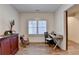 Cozy living room with hardwood floors and a wooden desk, offering a perfect blend of comfort and functionality at 1006 Fendley St, Woodstock, GA 30188