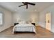 Spacious main bedroom with hardwood floors, a ceiling fan, and ensuite bathroom access for added convenience at 1006 Fendley St, Woodstock, GA 30188