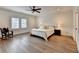 Serene main bedroom with hardwood floors, and a ceiling fan, offering a peaceful retreat at 1006 Fendley St, Woodstock, GA 30188