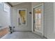 Cozy outdoor patio with a concrete floor, exterior door, and double hung window at 1006 Fendley St, Woodstock, GA 30188