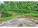 Overgrown backyard, including patio and terraced yard with lush greenery at 1523 Pangborn Station Dr, Decatur, GA 30033