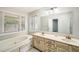 Bathroom with double sink vanity and bathtub under a window at 1523 Pangborn Station Dr, Decatur, GA 30033