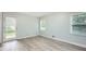 Bright bedroom with wood flooring, two windows, and access to outdoor patio at 1523 Pangborn Station Dr, Decatur, GA 30033