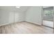 Bright bedroom with skylight, closet with bifold doors, and wood-look flooring with adjacent window at 1523 Pangborn Station Dr, Decatur, GA 30033