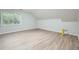 Attic bedroom featuring wood-look floors, window, and neutral walls at 1523 Pangborn Station Dr, Decatur, GA 30033