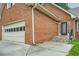 Two-story brick house featuring a two-car garage and a glass-paneled front door at 1523 Pangborn Station Dr, Decatur, GA 30033