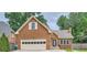 Charming brick home features an attached garage, a manicured lawn, and mature shade trees at 1523 Pangborn Station Dr, Decatur, GA 30033