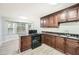 Kitchen featuring dark cabinets, laminate floors, and a center island at 1523 Pangborn Station Dr, Decatur, GA 30033
