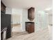 Open-concept kitchen featuring dark cabinetry, laminate floors, and stainless steel appliances at 1523 Pangborn Station Dr, Decatur, GA 30033