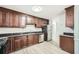 Kitchen with stainless steel appliances, dark cabinetry, and laminate floors at 1523 Pangborn Station Dr, Decatur, GA 30033