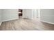 Spacious living room featuring light gray walls, laminate flooring, and white trim at 1523 Pangborn Station Dr, Decatur, GA 30033