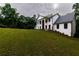 Backyard view of the house with a small patio and landscaping at 4 Bentley Trace Mnr, Atlanta, GA 30327