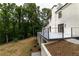 Exterior view of backyard showing deck with modern railing and landscaping, with a stone staircase to the yard at 4 Bentley Trace Mnr, Atlanta, GA 30327