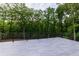 Wide open deck space with outdoor railing and a scenic backyard view surrounded by lush greenery at 4 Bentley Trace Mnr, Atlanta, GA 30327