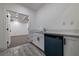 Stylish bar area features sleek countertops, white cabinets, blue dishwasher, and open access to a spacious room at 4 Bentley Trace Mnr, Atlanta, GA 30327