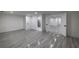 Spacious basement featuring elegant gray wood-look tile flooring, creating a stylish and durable living space at 4 Bentley Trace Mnr, Atlanta, GA 30327