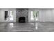 Finished basement with gorgeous fireplace with elegant tile surround and patio access, adding warmth and style at 4 Bentley Trace Mnr, Atlanta, GA 30327
