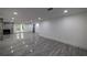 Finished basement featuring modern lighting, gray wood-look flooring and an ornamental fireplace at 4 Bentley Trace Mnr, Atlanta, GA 30327