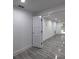 Finished basement with neutral walls and tile floors, leading to an open doorway at 4 Bentley Trace Mnr, Atlanta, GA 30327